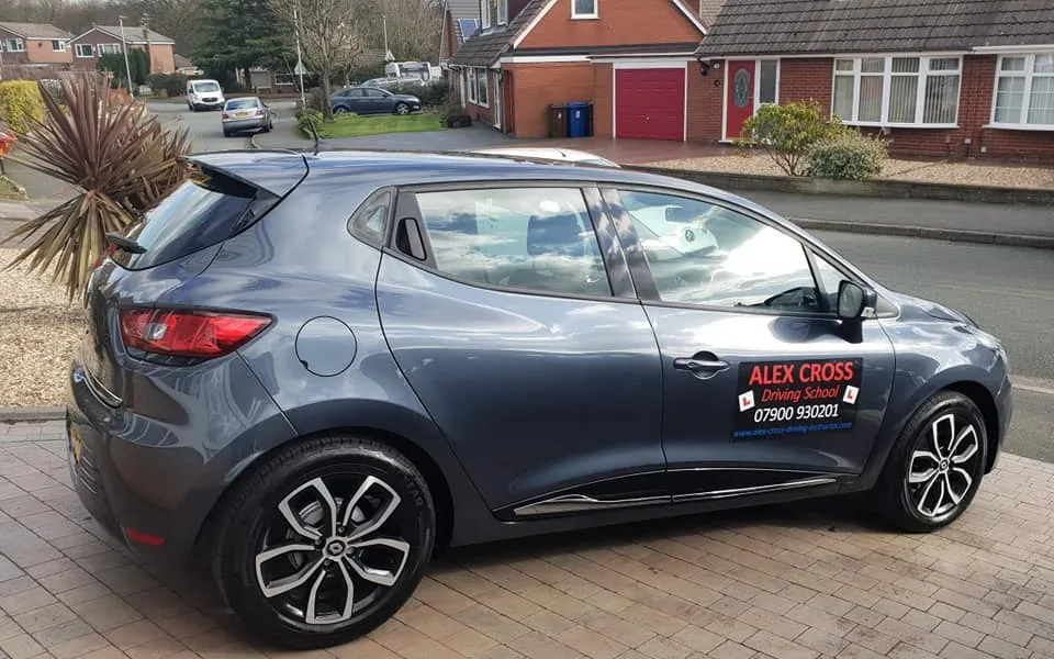 Alex's grey Renault Clio with Alex Cross Driving School signs on the door